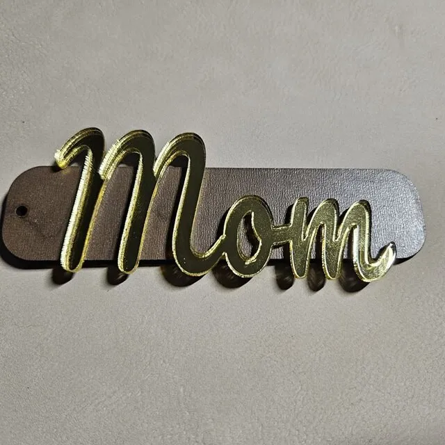 Beautiful stocking tag with Mom text in gold mirror acrylic and walnut plywood